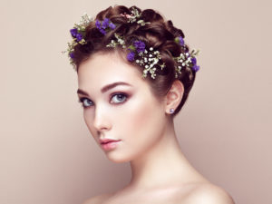 Face of beautiful woman decorated with flowers